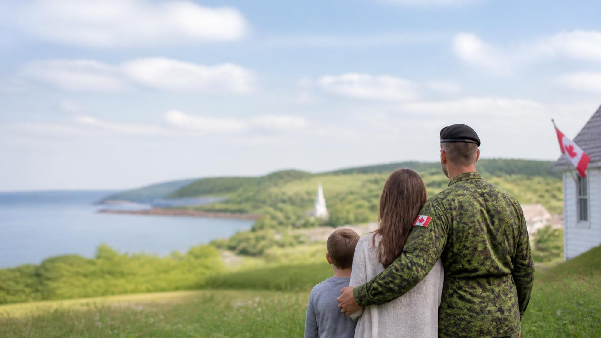 Canadian Armed Forces member embracing his family as they look out over a Nova Scotia bay